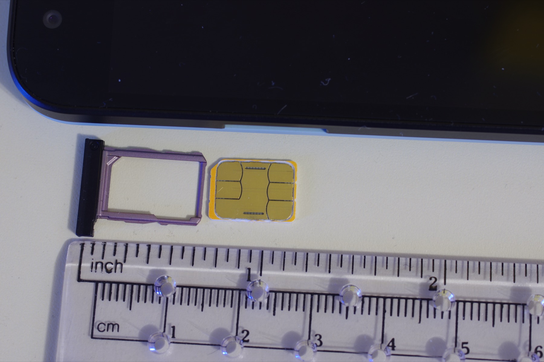 Una nano SIM junto a la bandeja de un teléfono